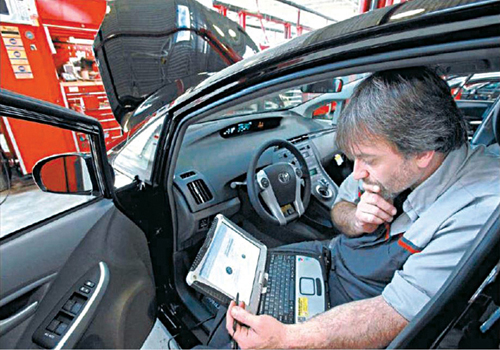 Fig. 4: A master diagnostic technician using a laptop computer to diagnose and repair the brake system (Source: http://www.cbsnews.com)