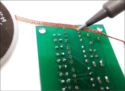 De-soldering using a solder braid