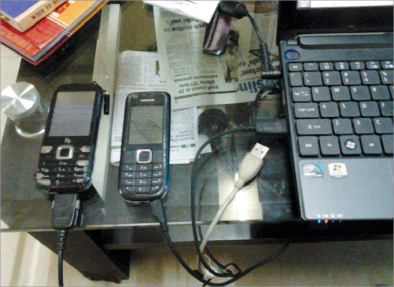 Author’s old mobile phones connected to a laptop for live streaming