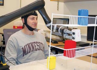 Research subjects at University of Minnesota fitted with a specialised non-invasive brain cap were able to move the robotic arm just by imagining moving their own arms (Image courtesy: University of Minnesota)