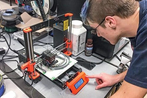 A 3D printer being used to print personal protective equipment in response to the lack of safety gear for medical professionals