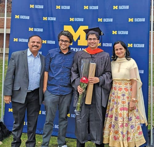 Family picture with younger son Aditya holding his degree