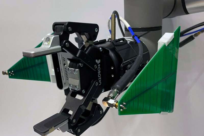 A Robotic Arm Combines Data From A Camera And Antenna To Locate And Retrieve Items