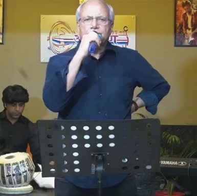 Ajai Chowdhry singing at a concert 