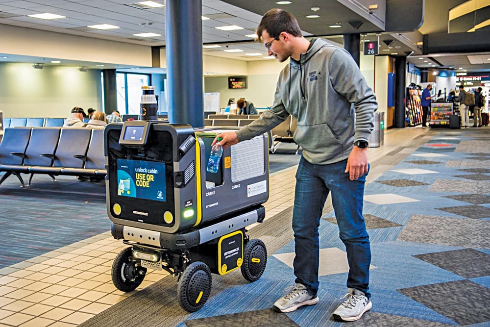 Ottobot 2.0 delivering orders to a traveller at an airport (Courtesy: Ottobot.io)