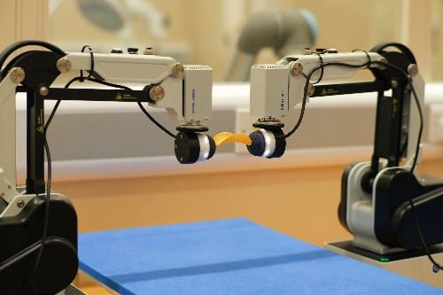 Dual-Arm Robot Learns Bimanual Tasks From Simulation
