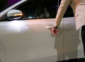 Asian businessman is unlocking car by using smart watch application