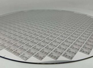 A 300 mm wafer with many memristive systems-on-a-chip.