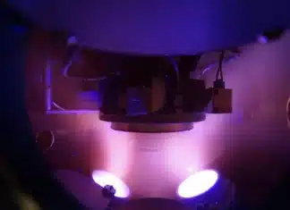 Argon plasma in the vacuum chamber during magnetron sputtering, with the substrate in the centre of the photograph