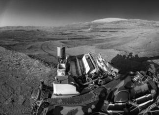 This view of tracks trailing NASA’s Curiosity was captured July 26, 2025, as the rover simultaneously relayed data to a Mars orbiter. Combining tasks like this more efficiently uses energy generated by Curiosity’s nuclear power source, seen here lined with rows of white fins at the back of the rover