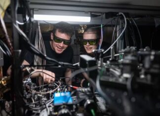 Connecting Quantum Computers Using Just Light Dougal Main and Beth Nichol working on the distributed quantum computer.
