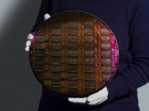 IBM researcher holding 300mm IBM Quantum Loon wafer (Credit: IBM)