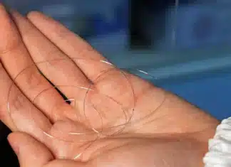 Researchers demonstrating hair-thin fibers integrated with electronic components
