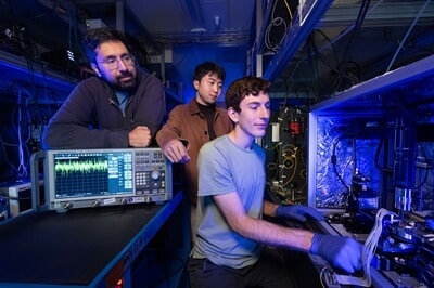 (From left) Amir Safavi-Naeini, senior author of the study, and co-authors Taewon Park and Devin Dean prepare to measure an optical amplifier chip. Courtesy of Stanford University.