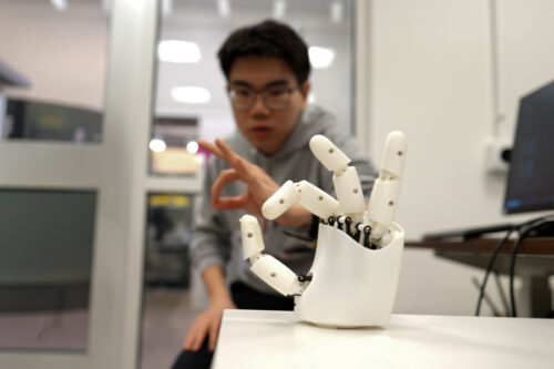 Graduate student Dian Li working with a robotic hand.
Credits:Credit: Melanie Gonick