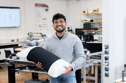 PhD researcher Malindu Ehelagasthenna with the smart pillow sleeve prototype.