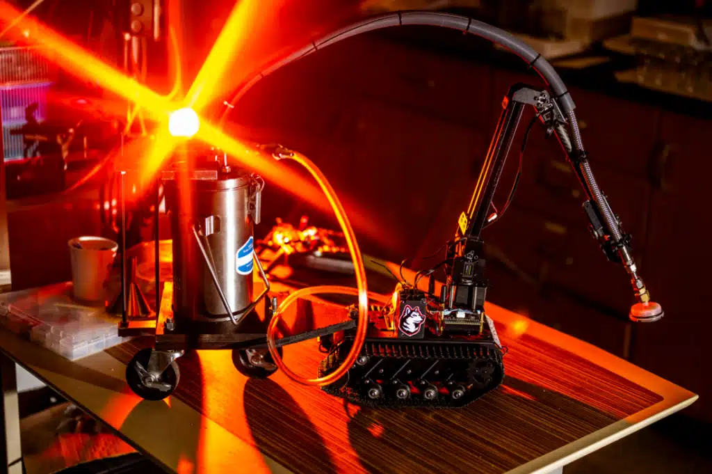 A prototype of a firefighting robot uses a cryogenic liquid to snuff out wildfire hotspots. It is being developed by Northeastern University. Photo by Matthew Modoono/Northeastern University