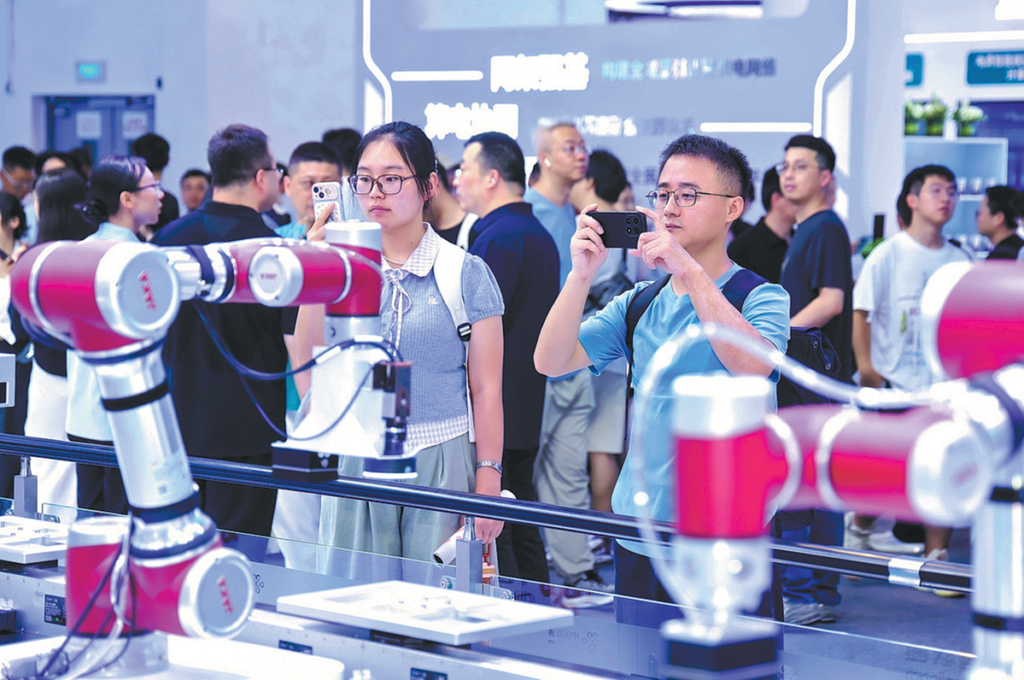 Visitors take photos at China Unicom's exhibition area during the 2026 World Artificial Intelligence Conference in Shanghai in July.