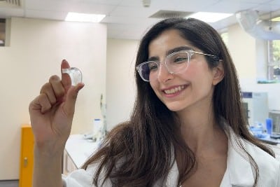 Study lead author Saba Firouznia holding the flexible pump embedded with a tiny liquid metal droplet, which supercharges its performance capability.