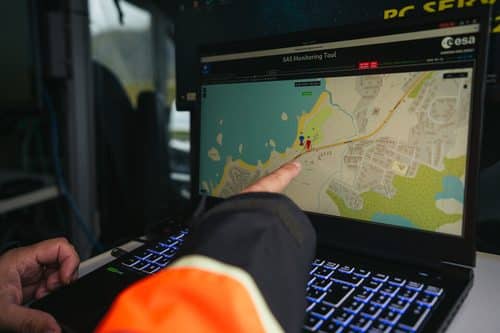 A person points at the ESA SAS Monitoring Tool on a laptop screen, showing a live position fix on a map during the Galileo spoofing test