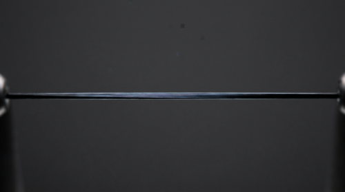 Close-up illustration of a fine fibre strand suggesting graphene's aligned sheet structure