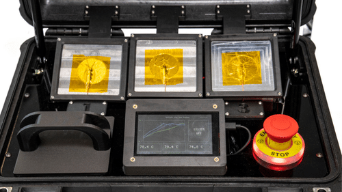 Close-up of a temperature monitoring display showing live readings from three phase-change heatsink test panels