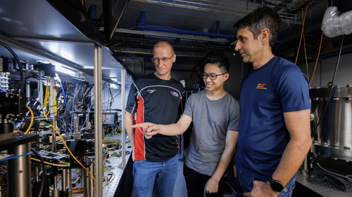 Associate Professor Murray Barrett, PhD student Michael Lee and Senior Research Scientist Kyle Arnold examining the lutetium-ion optical atomic clock apparatus at NUS