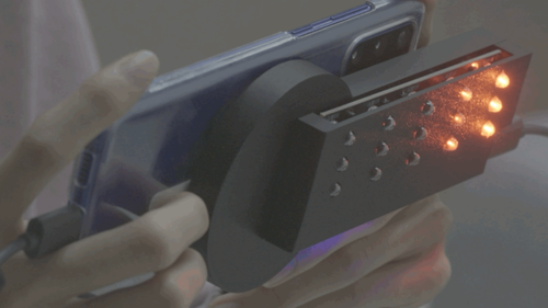 Close-up of the illuminated LED array on the SweepLED attachment during an active scan