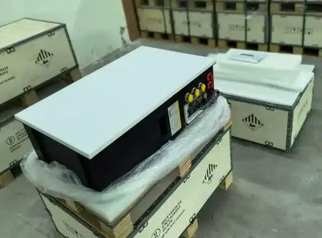 AuroraCell sodium-ion residential battery units packed on wooden pallets in a warehouse in Poland, ready for shipment