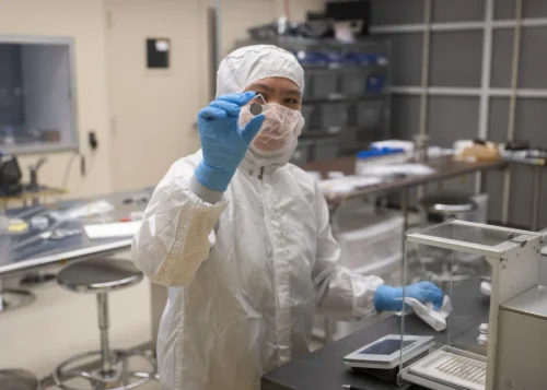 Nike Lin, a support engineer/technician on the thermal vacuum team, takes weight measurements of batteries following thermal vacuum testing. (Image credit: NASA/Ryan Hill)