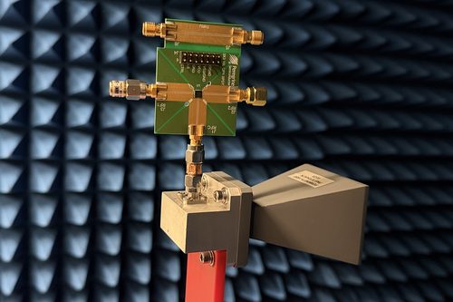 Close-up of the thermal-noise transmitter circuit board and horn antenna, showing RF connectors and a Peregrine Semiconductor switch chip